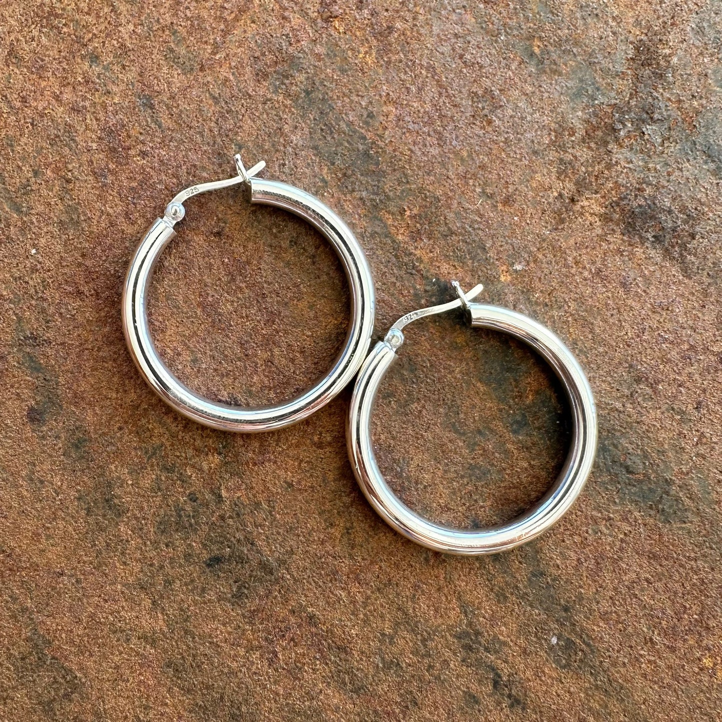 Medium sterling silver hoop earrings flat lay, Primitive Earth Australian jewellery