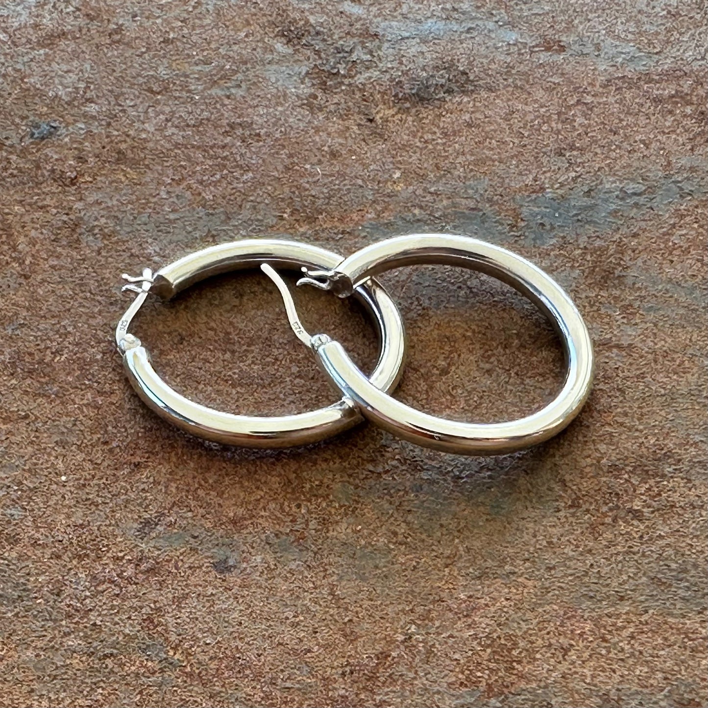 Medium sterling silver hoop earrings angled view, Primitive Earth Australian jewellery


