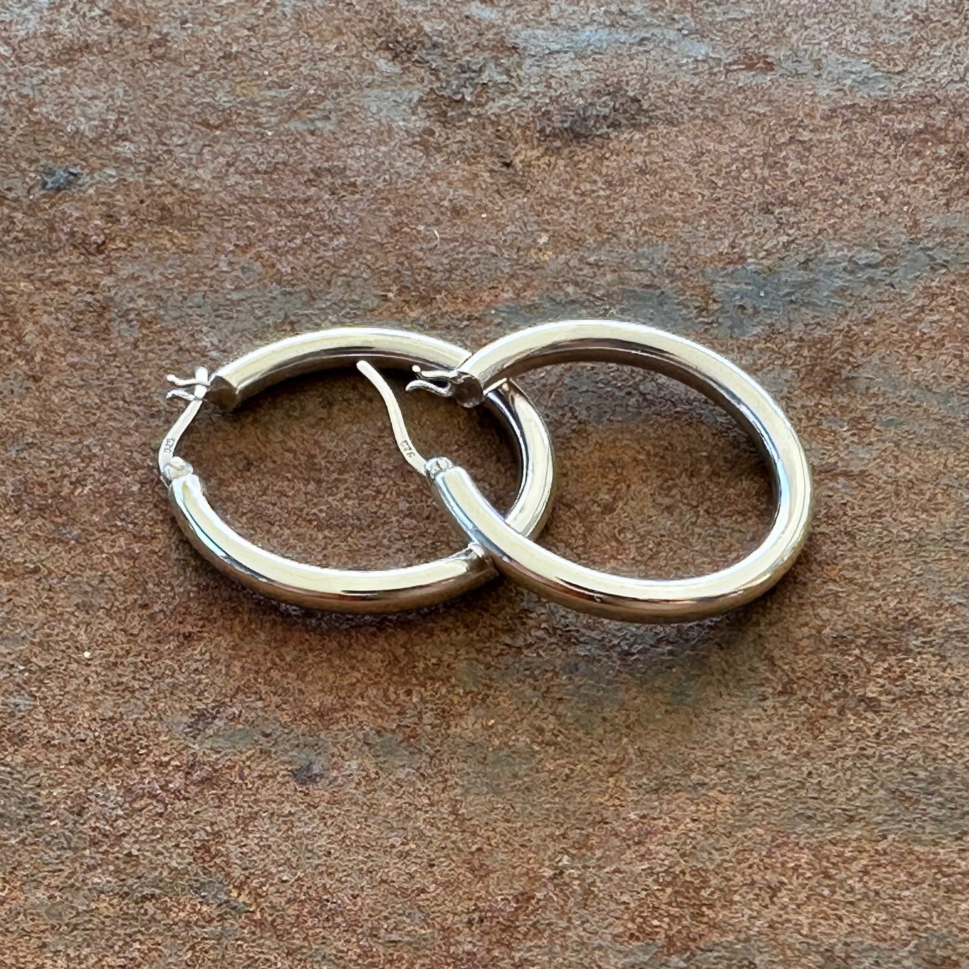 Medium sterling silver hoop earrings angled view, Primitive Earth Australian jewellery


